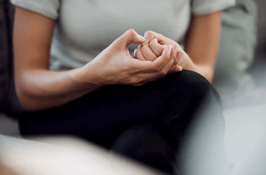 anxious woman clasped hands