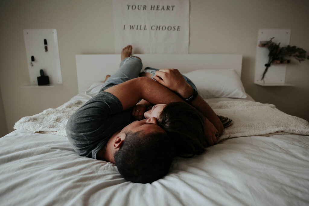 couple cuddling on bed couple cuddling on bed