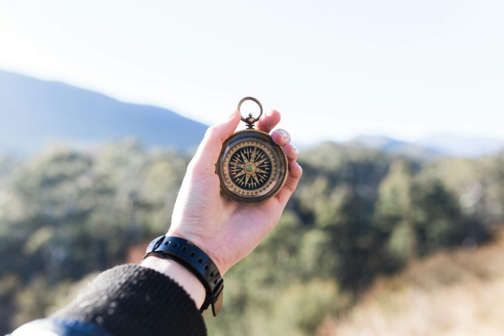 hand holding vintage compass hand holding vintage compass