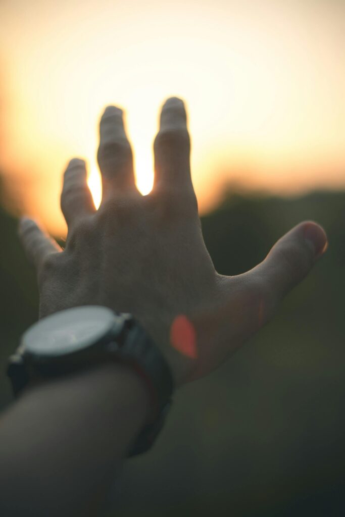 hand reaching sunset light hand reaching sunset light