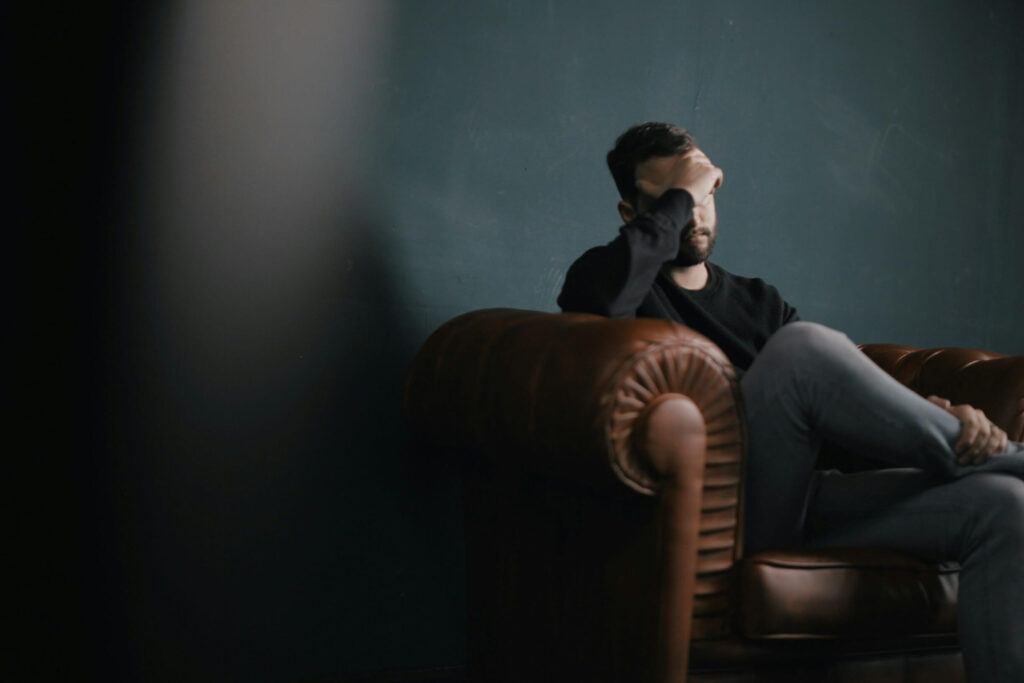 man sitting feeling stressed man sitting feeling stressed