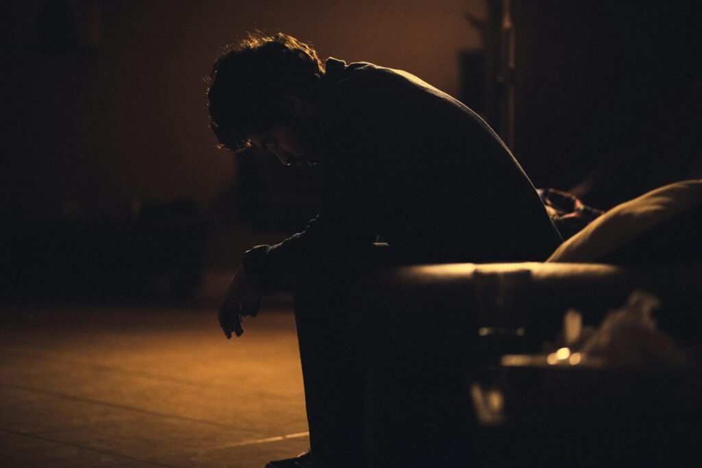 man sitting in shadow
