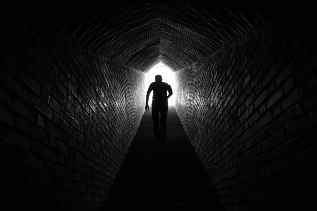 silhouette walking dark tunnel silhouette walking dark tunnel