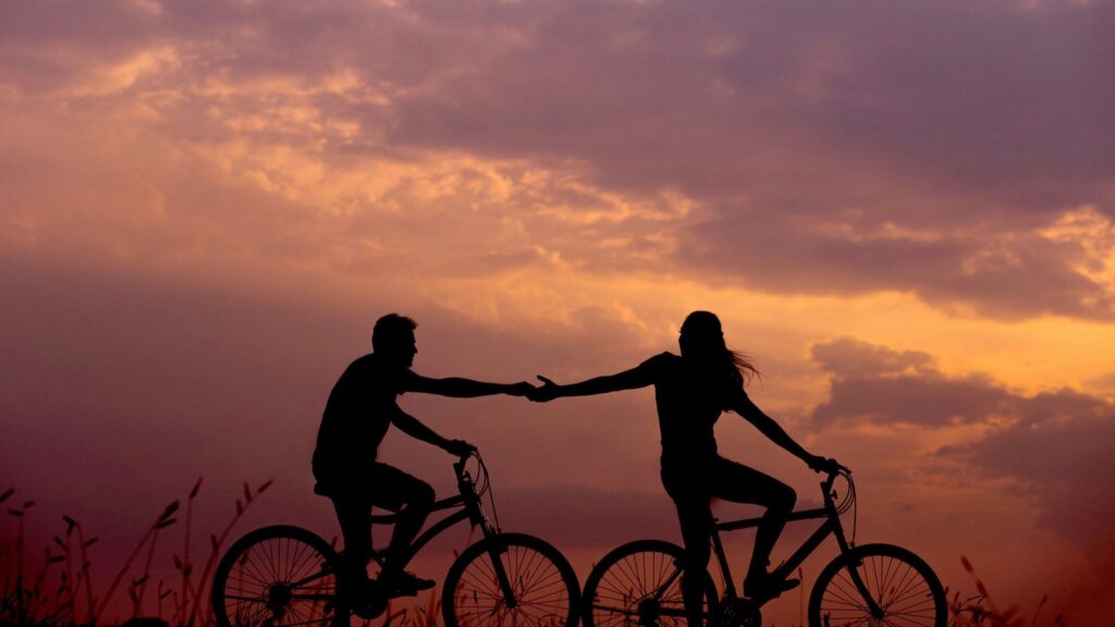 sunset couple biking silhouette